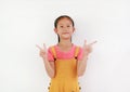 Asian little girl child gesture finger pointing at beside against white background