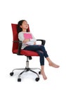 Asian little girl child sleeping with hugging a book sitting on red fabric chair  over white background. Image in studio Royalty Free Stock Photo