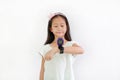 Asian little girl child using smart watch video camera against white background. Focus at smart watch at his hands Royalty Free Stock Photo