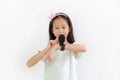 Asian little girl child using smart watch video camera against white background. Focus at smart watch at his hands Royalty Free Stock Photo