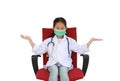 Asian little girl child in white doctor gown and protective mask with open arms wide sitting on red chair isolated on white studio Royalty Free Stock Photo