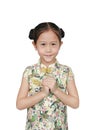 Asian little girl in chinese traditional dress with greeting gesture celebrating for happy Chinese New Year Royalty Free Stock Photo