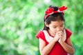 Asian little girl in christmas dress folded her hand in prayer