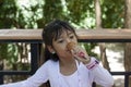 Asian little girl eating ice cream with deliciousness.