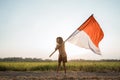 Asian little girl flapping Indonesian flag Royalty Free Stock Photo