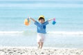 Asian little girl have fun and play yellow ball on the beach. Family kid tourism travel enjoy and freedom in summer and holiday f