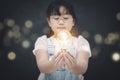 Asian Little girl holding the light bulb  in graph Screen Icon of media screen,Technology Process System Business,E-learning Educa Royalty Free Stock Photo