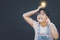 Asian Little girl holding the light bulb  in graph Screen Icon of media screen,Technology Process System Business,E-learning Educa Royalty Free Stock Photo