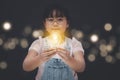 Asian Little girl holding the light bulb  in graph Screen Icon of media screen,Technology Process System Business,E-learning Educa Royalty Free Stock Photo