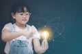 Asian Little girl holding the light bulb and touch in graph Screen Icon of media screen,Technology Process System Business,E-learn Royalty Free Stock Photo