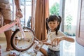 Asian little girl holding new unassembled mini bicycle handlebars