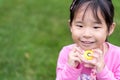 Asian little girl holding a plastic camera toy Royalty Free Stock Photo