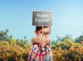 Asian little girl holding sign board plank with Happy easter greeting Royalty Free Stock Photo