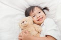 Asian little girl hugging the teddy bear Royalty Free Stock Photo