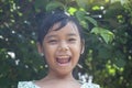 Asian little girl laughed brightly on blur nature background.