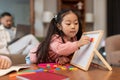 Asian Little Girl Learning Alphabet Playing With Magnetic Board Indoors Royalty Free Stock Photo