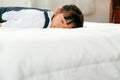 Asian little girl lie and sleep on white bed with the condition of peaceful and relax time Royalty Free Stock Photo