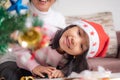 Asian little girl look at the Christmas tree and smile with happines