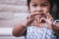 Asian little girl making heart shape with hands Royalty Free Stock Photo