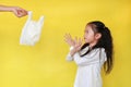 Asian little girl making X sign her arms for needless a white thin polythene plastic bag to Reduce or zero waste isolated on