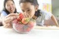 Asian little girl and mother picking straberry in glass bowl, Se