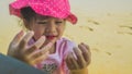 Asian little girl plaing sand on beach outdoor