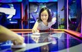 Asian little girl playing arcade game on the computer machines at the shopping mall outlets,holiday activities of cute child play