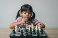 Asian little girl playing chess at home.a game of chess Royalty Free Stock Photo