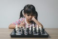 Asian little girl playing chess at home.a game of chess Royalty Free Stock Photo