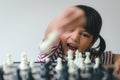 Asian little girl playing chess at home.a game of chess Royalty Free Stock Photo