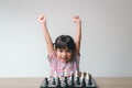 Asian little girl playing chess at home.a game of chess Royalty Free Stock Photo