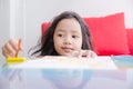 Asian little girl playing with crayon color selective focus shallow depth of field Royalty Free Stock Photo