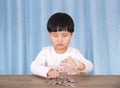 Asian little girl playing with dollar coins in glass bottle Royalty Free Stock Photo