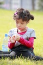 Asian little girl playing on grass Royalty Free Stock Photo