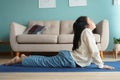 Asian little girl practicing yoga cobra pose on yoga mat in the living at home, Concept of relaxation and meditation Royalty Free Stock Photo