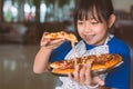 Asian little girl preparing homemade pizza with smile and happy Royalty Free Stock Photo