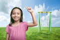 Asian little girl raised hands with swing Royalty Free Stock Photo