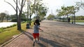 Asian little girl running in public park with camera follower