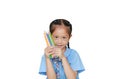 Asian little girl in school uniform holding color pencils over white background. Education and school concept Royalty Free Stock Photo