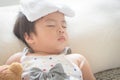 Asian little girl sleep and sick on sofa with cooler gel on her Royalty Free Stock Photo