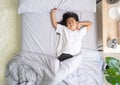 Asian little girl stretching hands as she is wake up in a bed Royalty Free Stock Photo