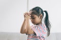 Asian little girl suffering from headache at home.Cute asian child girl touching her head Royalty Free Stock Photo