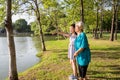 Asian little girl supporting senior woman with walking stick,happy smiling grandmother and granddaughter in outdoor park,elderly Royalty Free Stock Photo