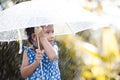 Asian little girl with umbrella in rain Royalty Free Stock Photo