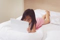 Asian little girl using tablet computer in bed Royalty Free Stock Photo