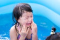 Asian little girl was crying heavily because she was playing in water with her younger sister and crashing. She hurt.