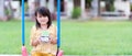 Asian little girl was sitting holding a coins bottle with the message