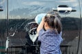 Asian little girl washing car Royalty Free Stock Photo