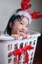 Asian little girl wearing a reindeer headband