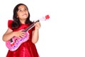 Asian little girl on white background isolated (6 year old) was playing the ukulele Royalty Free Stock Photo